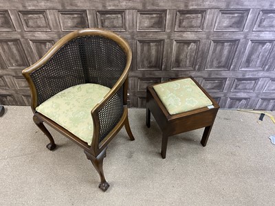 Lot 364 - A CANE BACK TUB CHAIR AND A SEWING TABLE