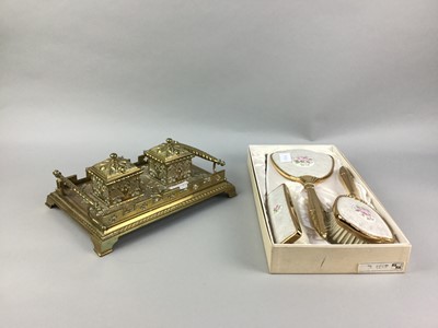 Lot 520A - A BRASS EMBOSSED INK STAND AND THREE PIECE VANITY SET