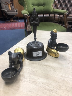 Lot 579 - AN EASTERN BRASS BELL ALONG WITH A PAIR OF TEA LIGHT HOLDERS