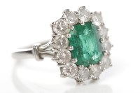 Lot 295 - EMERALD AND DIAMOND CLUSTER RING the central...