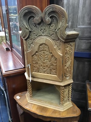 Lot 87 - A CARVED WOOD WALL MOUNTING CORNER CABINET