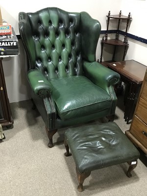 Lot 276 - A GREEN LEATHER WING BACK ARMCHAIR AND MATCHING FOOTSTOOL