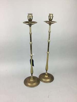 Lot 600 - A PAIR OF TALL BRASS CANDLESTICKS AND TWO LAMPS