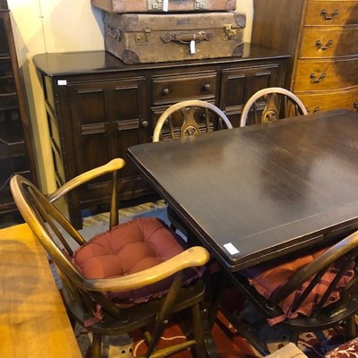 Lot 748 - AN ERCOL DRESSER, DINING TABLE AND SIX CHAIRS