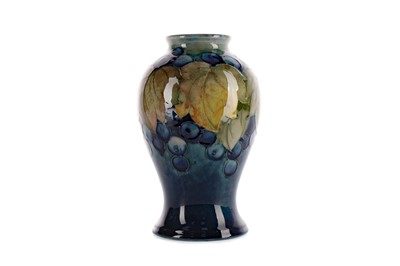 Lot 1086 - A MOORCROFT 'LEAVES AND BERRIES' PATTERN VASE