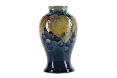 Lot 1086 - A MOORCROFT 'LEAVES AND BERRIES' PATTERN VASE