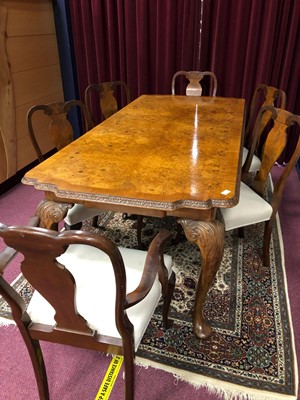 Lot 447 - A WALNUT DINING TABLE AND CHAIRS