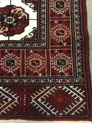 Lot 843 - PERSIAN FRINGED RUG, decorated in shades of...