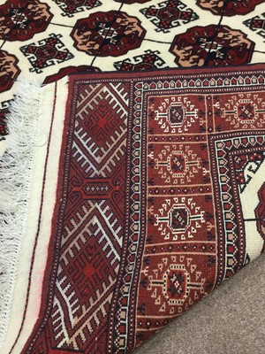 Lot 843 - PERSIAN FRINGED RUG, decorated in shades of...