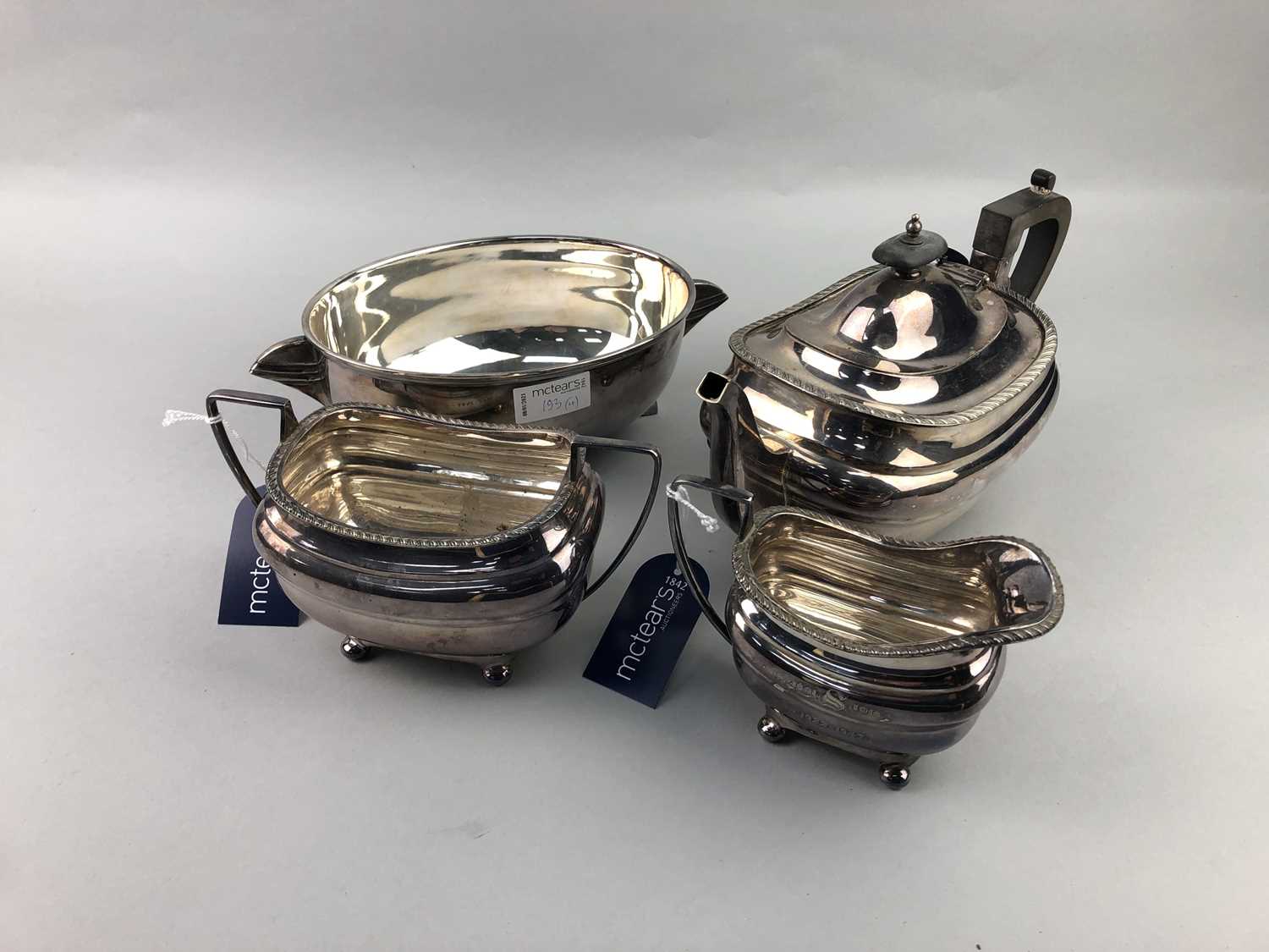 Lot 193 - A THREE PIECE SILVER PLATED TEA SERVICE AND AN ART DECO DISH