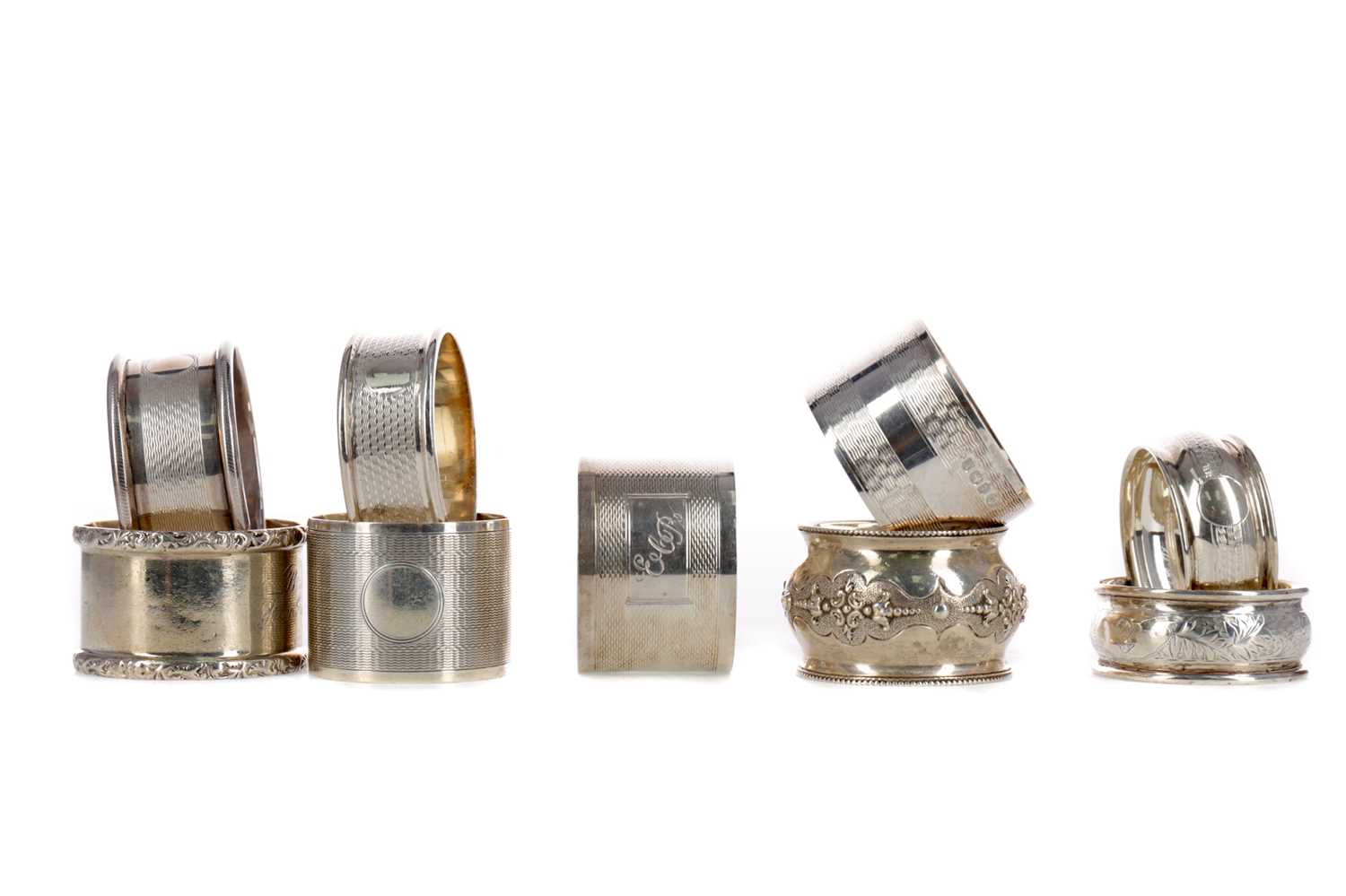Lot 407 - A COLLECTION OF EIGHT SILVER NAPKIN RINGS