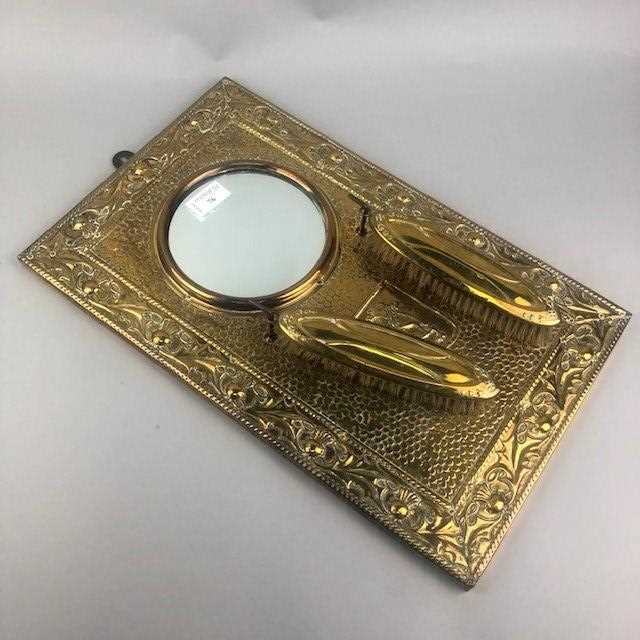 Lot 76 - A BRASS EMBOSSED WALL HANGING MIRROR AND BRUSH SET