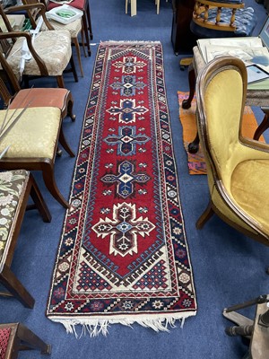 Lot 29 - A MIDDLE EASTERN FRINGED AND BORDERED RUNNER AND A RUG