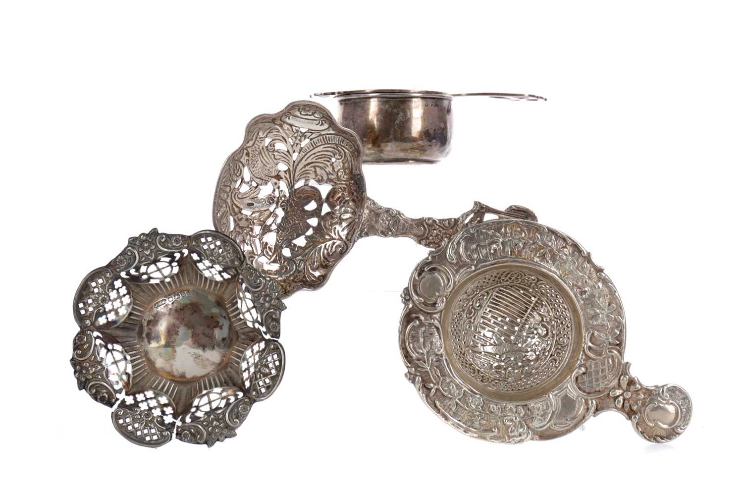 Lot 419 - A LOT OF THREE SILVER TEA STRAINERS, AND A BONBON DISH