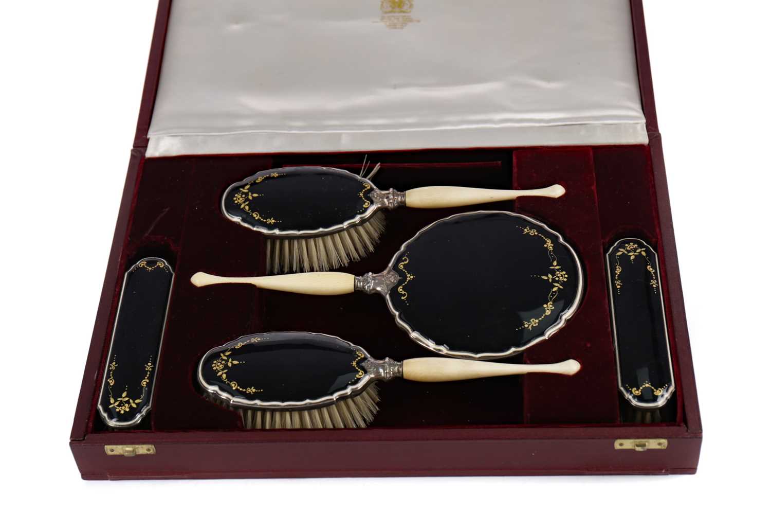 Lot 458 - A CASED GEORGE V SILVER AND ENAMEL DRESSING TABLE SET