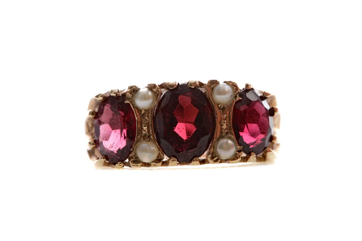 Lot 548 - A RED GEM SET AND SEED PEARL RING