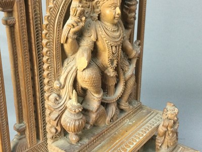 Lot 336 - AN EARLY 20TH CENTURY INDIAN CARVED SANDALWOOD FIGURE OF A DEITY