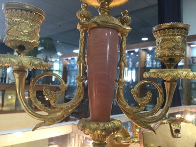 Lot 372 - A PAIR OF LATE 19TH CENTURY ORMOLU AND ROUGE MARBLE CANDELABRA