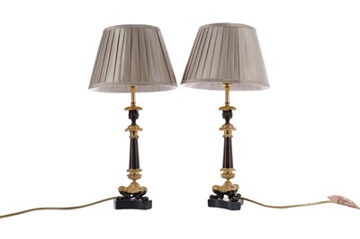 Lot 1607 - A PAIR OF REGENCY PATINATED AND GILDED BRONZE CANDLESTICKS CONVERTED TO LAMPS