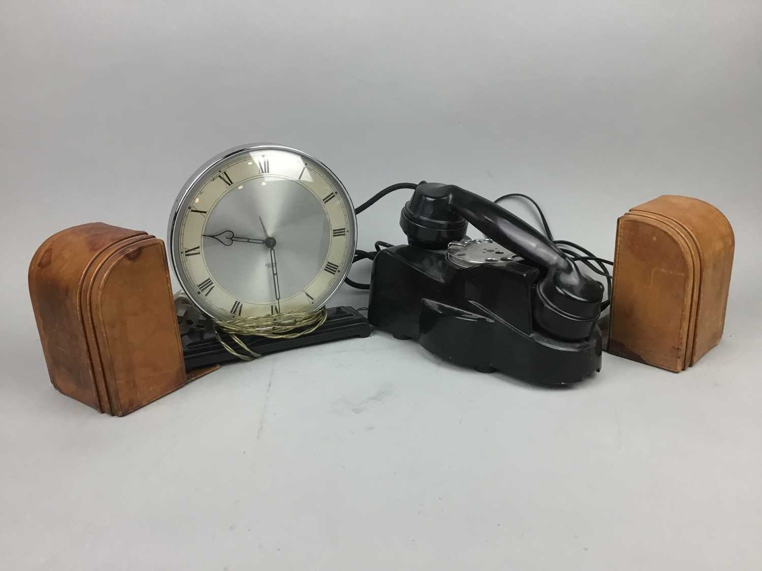 Lot 22 - AN EARLY 20TH CENTURY BAKELITE TELEPHONE, LEATHER BOOKENDS AND A MANTEL CLOCK