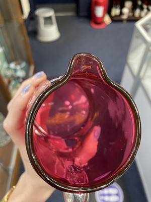 Lot 1159 - A LATE VICTORIAN CRANBERRY GLASS WATER JUG