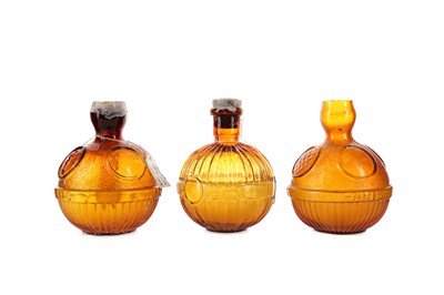 Lot 1165 - A GROUP OF THREE EARLY 20TH CENTURY AMBER GLASS  FIRE GRENADE EXTINGUISHERS