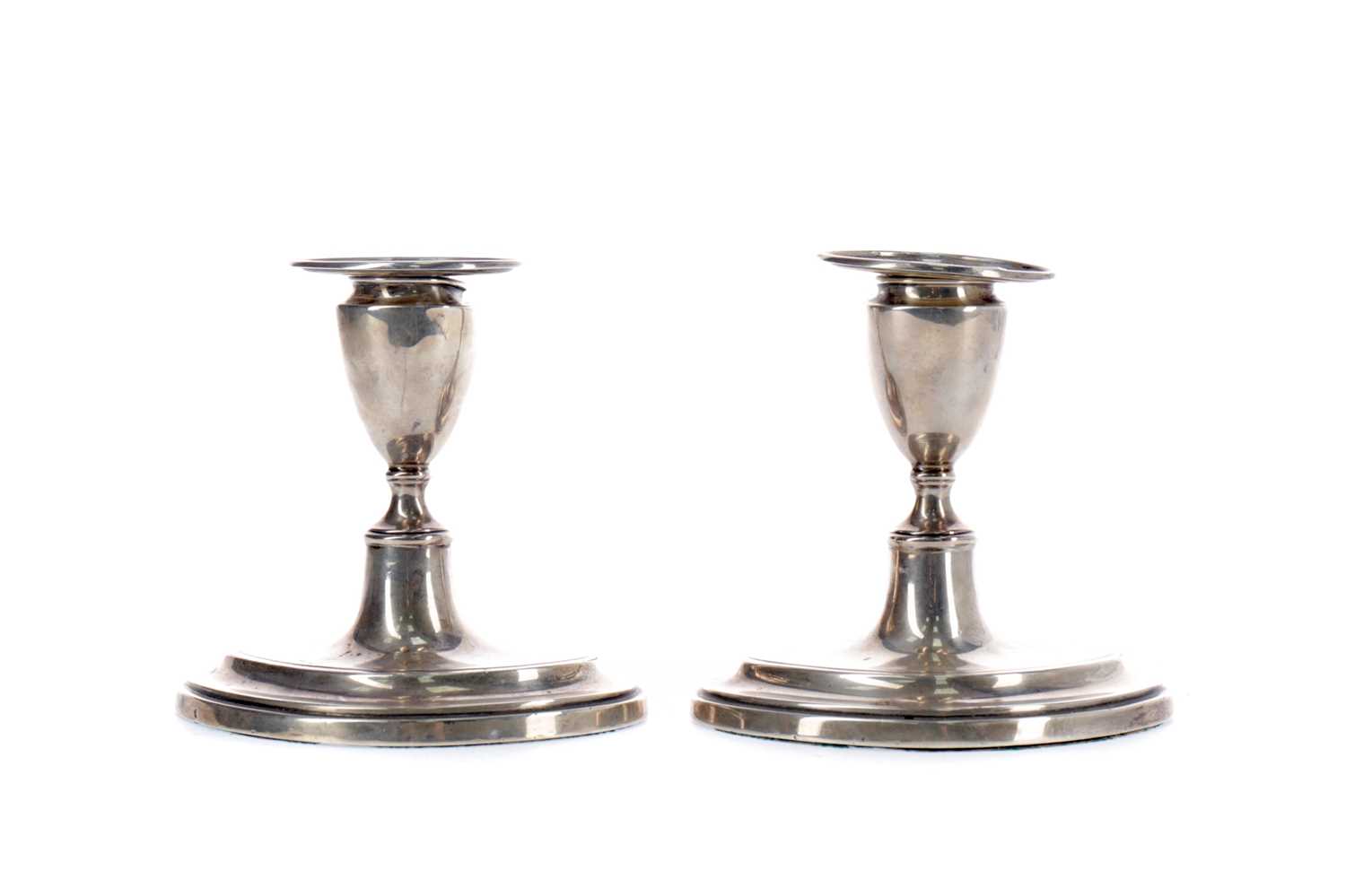 Lot 99 - A PAIR OF EDWARDIAN SILVER DWARF CANDLESTICKS