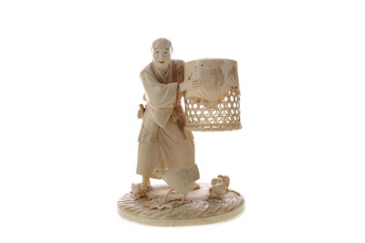 Lot 923 - A JAPANESE IVORY CARVING OF A MAN CATCHING CHICKENS
