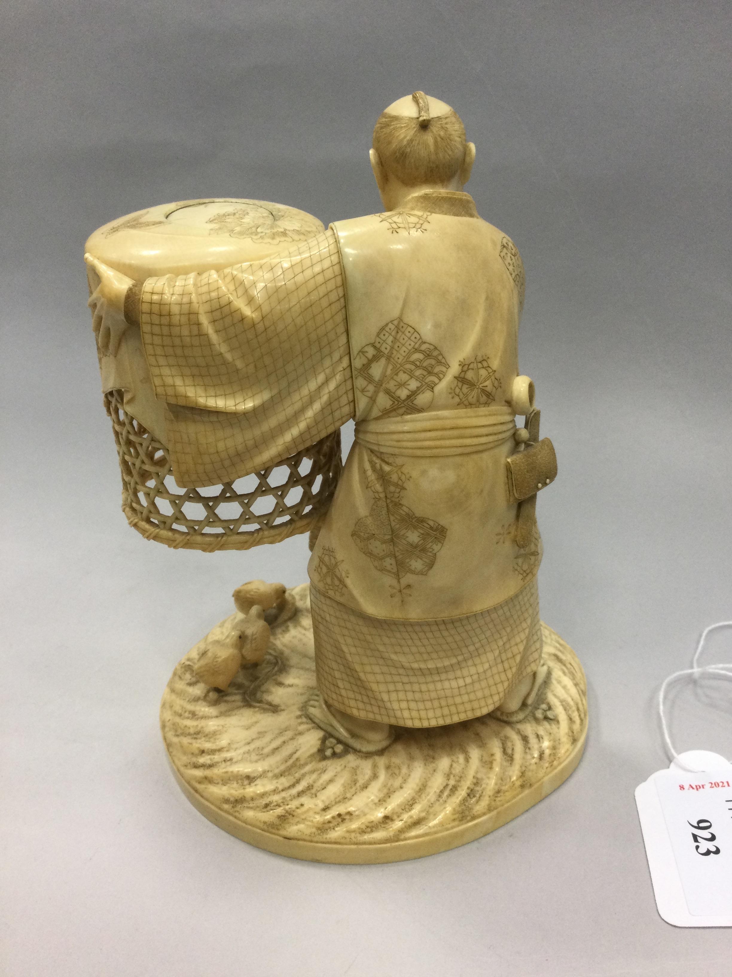 Lot 923 A JAPANESE IVORY CARVING OF A MAN CATCHING
