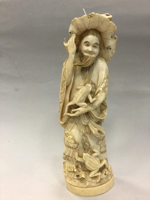 Lot 924 - A JAPANESE IVORY CARVING OF A MAN WITH FROGS