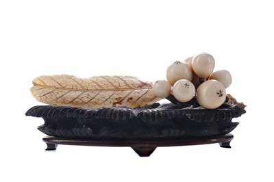 Lot 928 - A JAPANESE IVORY CARVING OF BERRIES AND LEAVES