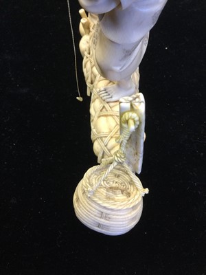 Lot 911 - A JAPANESE IVORY CARVING OF A FISHERMAN AND BOY