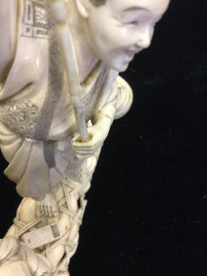 Lot 911 - A JAPANESE IVORY CARVING OF A FISHERMAN AND BOY