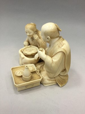 Lot 916 - A FINE JAPANESE IVORY CARVING OF A SEATED GROUP, WITH GOLD SEAL MARK