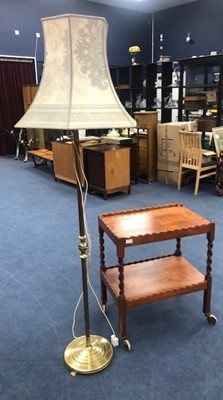 Lot 417 - AN OAK TEA TROLLEY AND A BRASS FLOOR LAMP