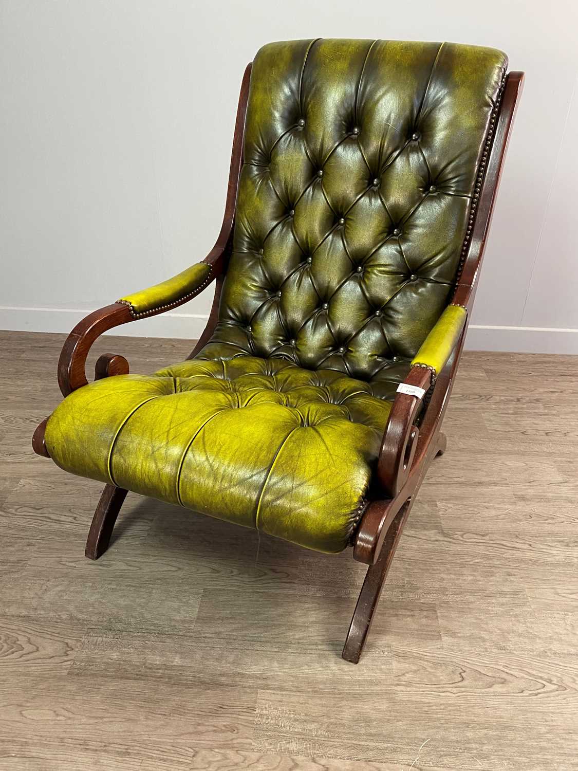 Lot 1309 - A GREEN LEATHER BUTTON BACK LIBRARY ARMCHAIR