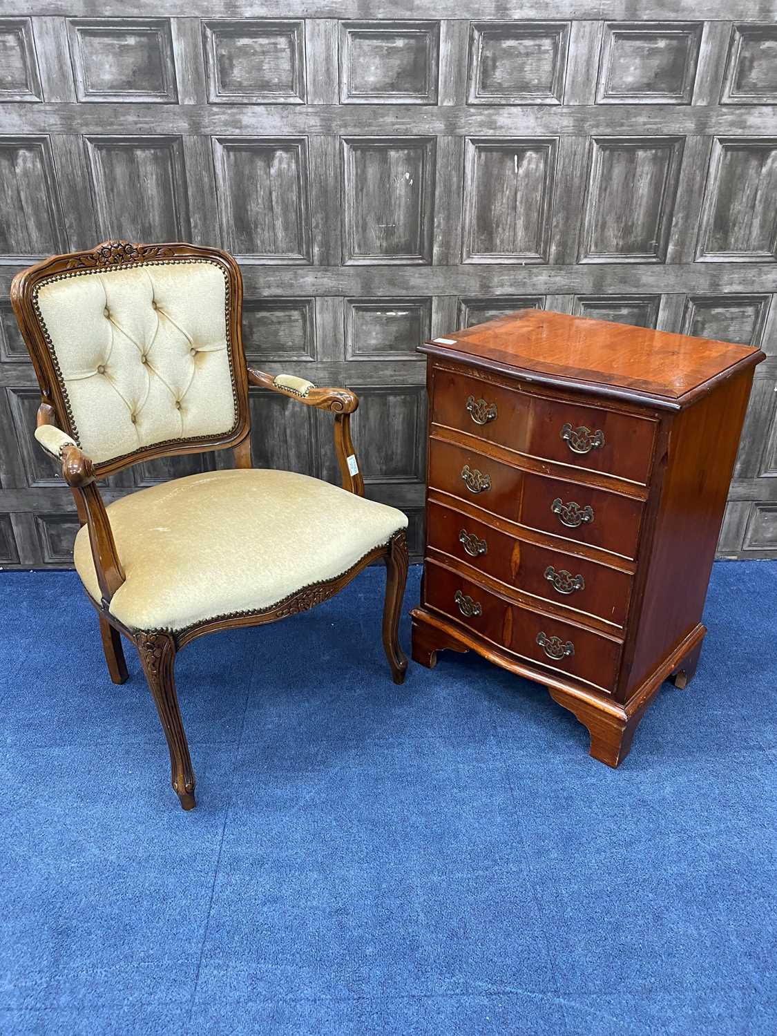 Lot 77 - A REPRODUCTION STAINED WOOD CHEST OF DRAWERS AND AN ELBOW CHAIR