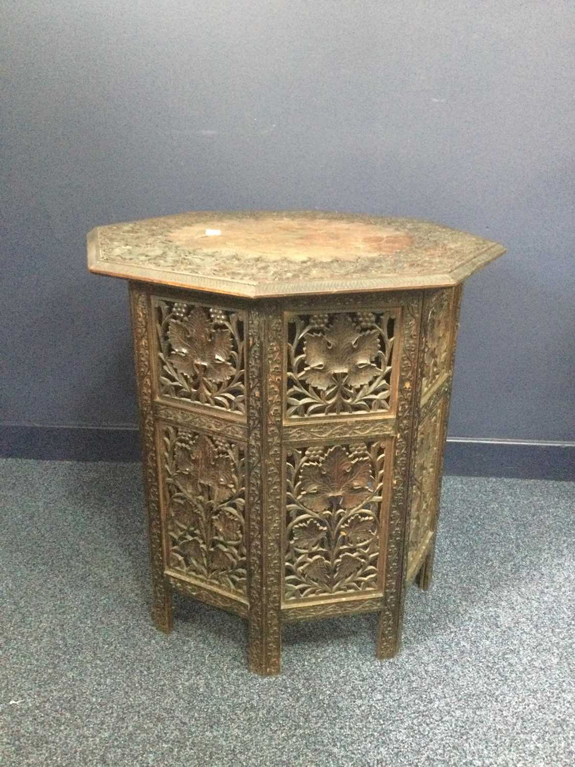 Lot 727 - AN INDIAN CARVED WOOD FOLDING TABLE