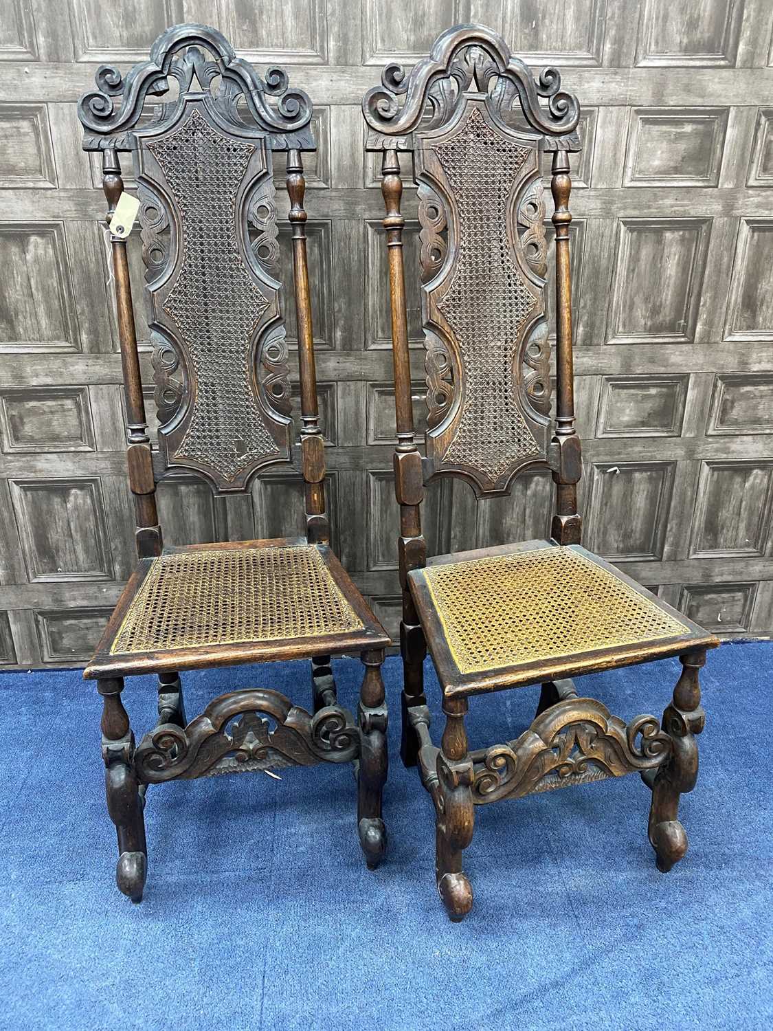 Lot 250 - A PAIR OF 19TH CENTURY CARVED OAK HALL CHAIRS