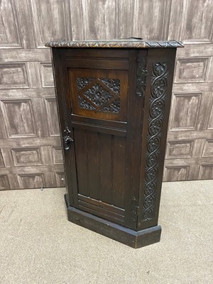 Lot 382 - A CARVED OAK CORNER CUPBOARD