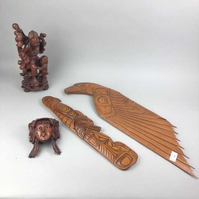 Lot 105 - A CHINESE CARVED ROOTWOOD FIGURE GROUP AND THREE WALL MASKS
