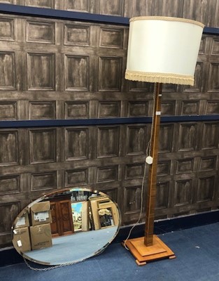 Lot 185 - AN OAK FLOOR LAMP AND AN OVAL BEVELLED WALL MIRROR