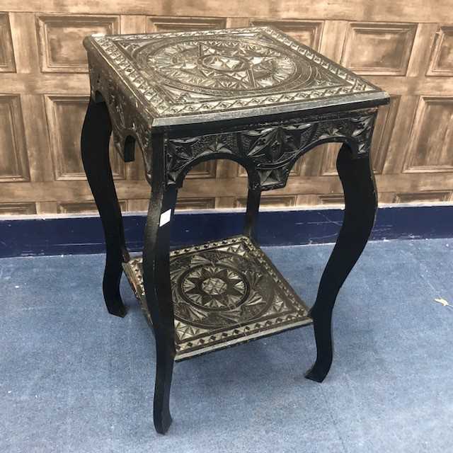 Lot 184 - A CARVED EBONISED SIDE TABLE