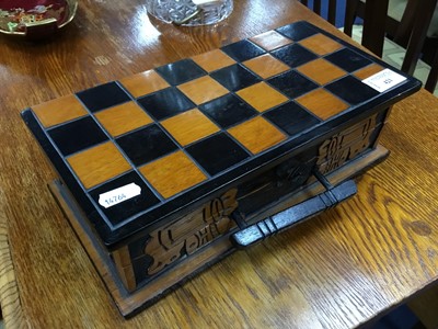Lot 421 - A CARVED WOOD TRAVEL CHESS BOARD