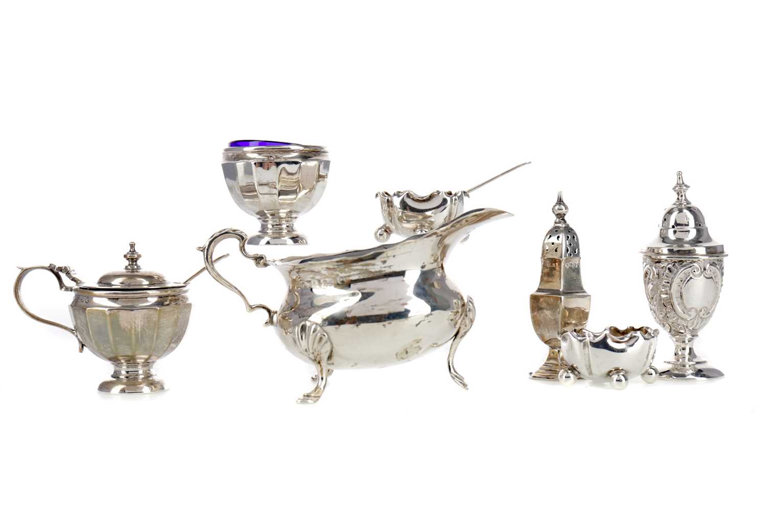 Lot 438 - AN EDWARDIAN SILVER CREAM JUG ALONG WITH CONDIMENTS