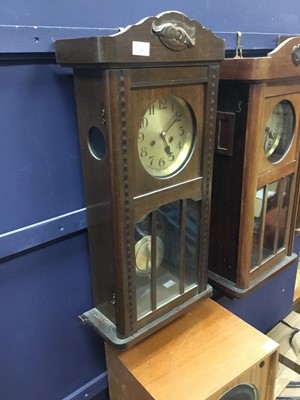 Lot 256 - AN EARLY 20TH CENTURY STAINED WOOD KITCHEN WALL CLOCK