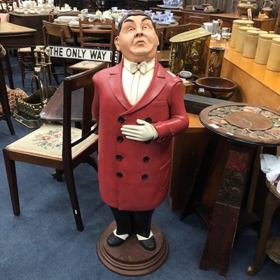 Lot 521 - A MODERN RESIN STANDING FIGURE MODELLED AS A MAN WITH RED JACKET