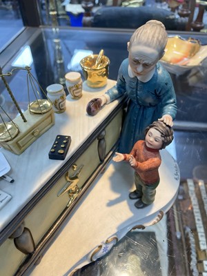 Lot 152 - A CAPODIMONTE GROUP OF THE PHARMACIST AND AN ADDERLAY FIGURE