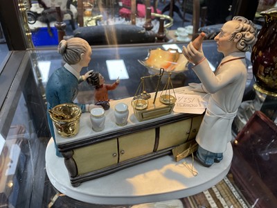 Lot 152 - A CAPODIMONTE GROUP OF THE PHARMACIST AND AN ADDERLAY FIGURE