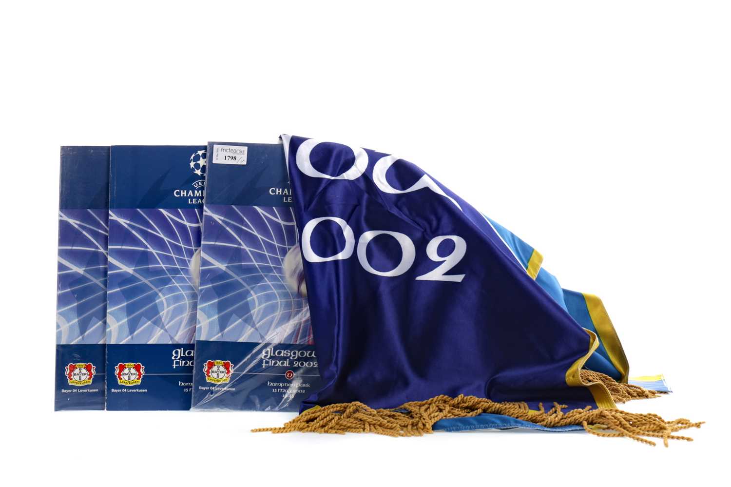 Lot 1798 - AN OFFICIAL BANNER FROM THE 2002 CHAMPIONS LEAGUE FINAL, ALONG WITH THREE PROGRAMMES